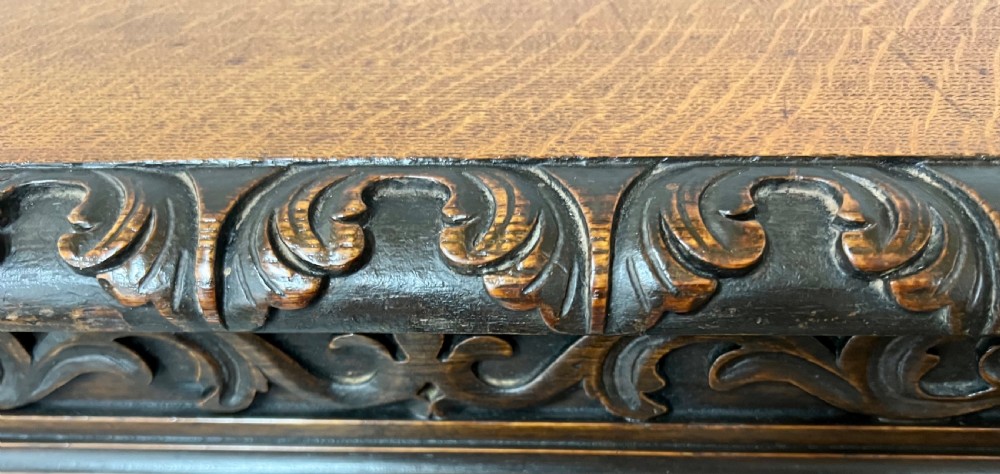 A dark oak Victorian rise and fall three-tiered dumb waiter with carved foliage borders and ornate leg supports. View IX