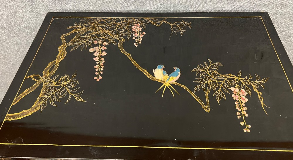 A black lacquered Chinoiserie cocktail cabinet on stand featuring hand-painted botanical motifs, birds, figures, and gilt cabriole legs. View V