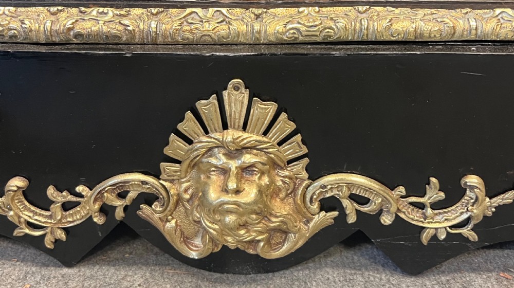 An ebonised two-door display cabinet featuring glass panels, detailed gilt bronze ormolu mounts, cherub term figures, and ornamental friezes. View XII