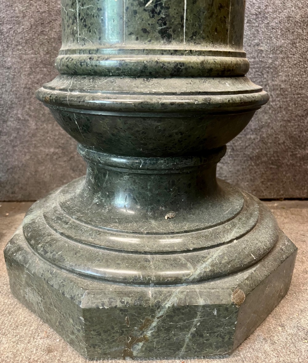 A pair of 19th-century carved dark green serpentine marble columns featuring fluted shafts, moulded capitals, and stepped octagonal bases. View VI