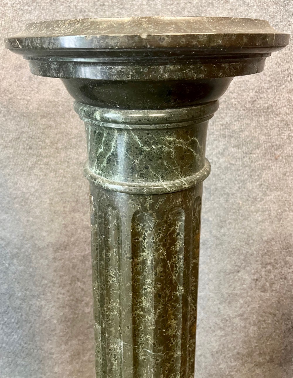 A pair of 19th-century carved dark green serpentine marble columns featuring fluted shafts, moulded capitals, and stepped octagonal bases. View VII
