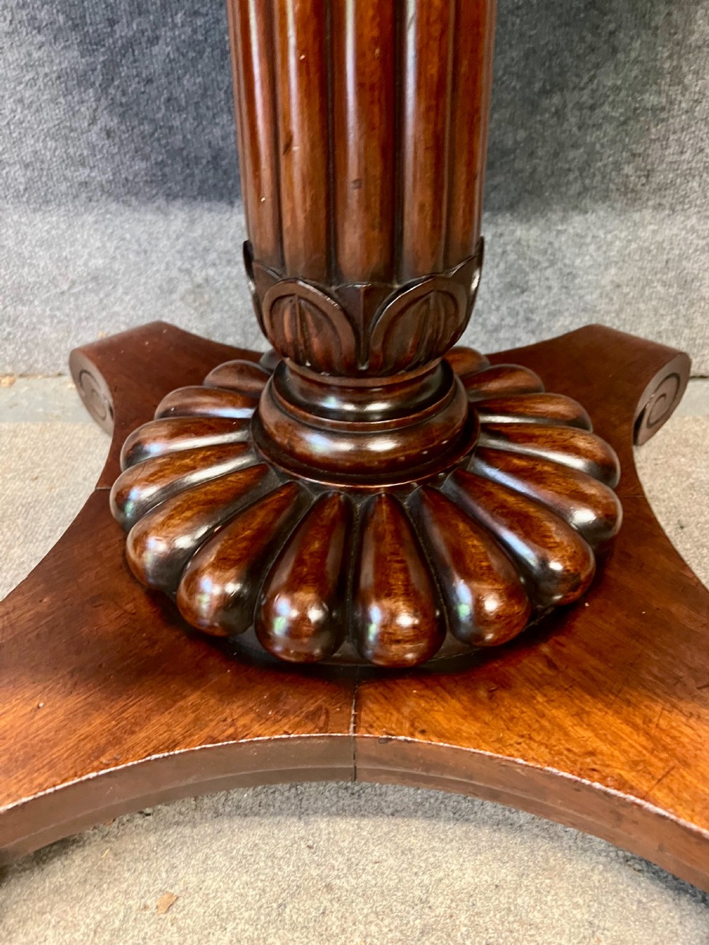 Antique William IV mahogany occasional table with two drawers, a reeded pedestal stem, and a scroll-foot base on brass castors. View II