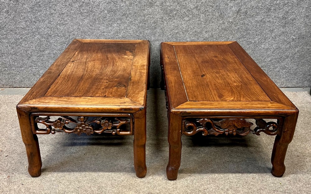 A matched pair of rectangular Chinese low hardwood tables with intricately carved openwork floral aprons and curved legs. View V