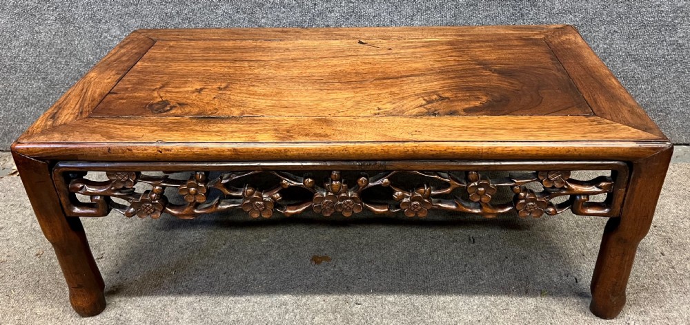 A matched pair of rectangular Chinese low hardwood tables with intricately carved openwork floral aprons and curved legs. View VI