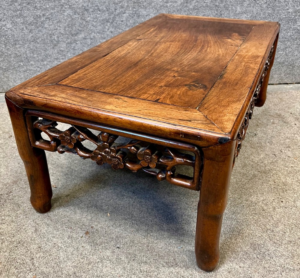 A matched pair of rectangular Chinese low hardwood tables with intricately carved openwork floral aprons and curved legs. View VII