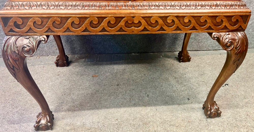 An open Edwardian mahogany folio cabinet featuring twin doors, internal sliding trays, carved top moulding, and claw and ball feet. View IV