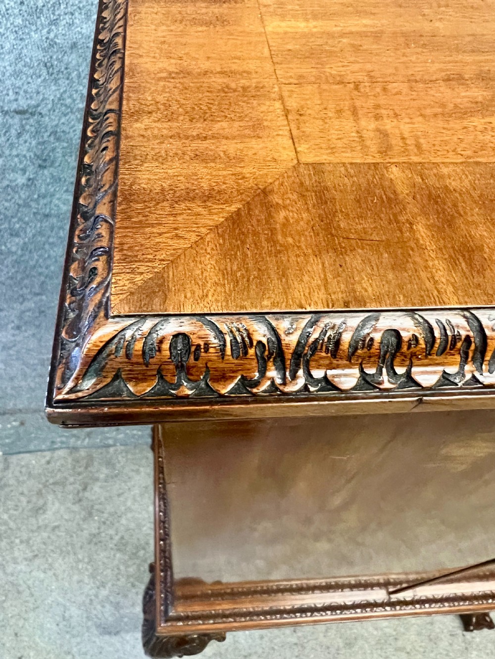 An open Edwardian mahogany folio cabinet featuring twin doors, internal sliding trays, carved top moulding, and claw and ball feet. View VIII