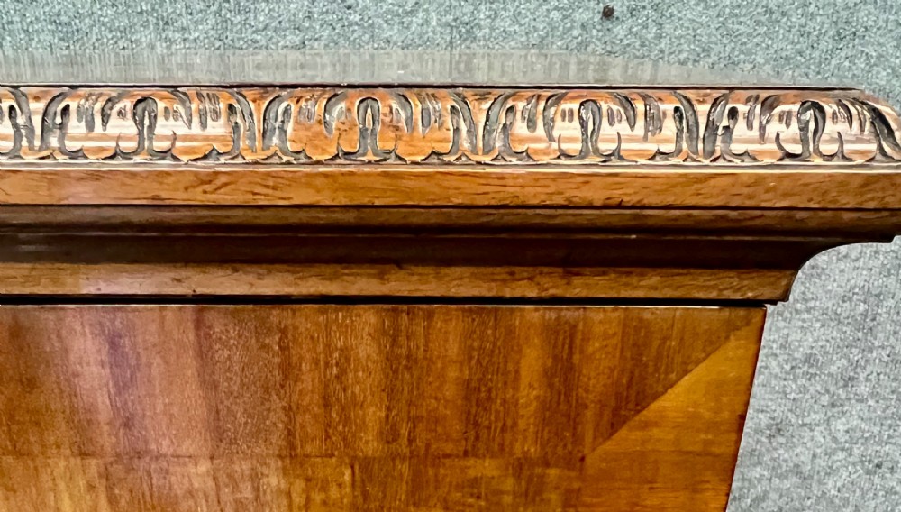 An open Edwardian mahogany folio cabinet featuring twin doors, internal sliding trays, carved top moulding, and claw and ball feet. View IX