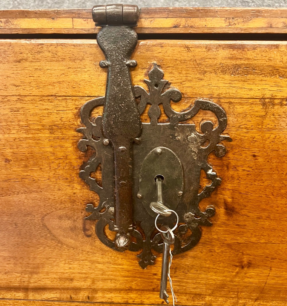 A 17th-century Spanish walnut Vargueno cabinet with an open drop-front writing flap revealing multiple fitted drawers, set on a trestle stand with iron stretchers. View III
