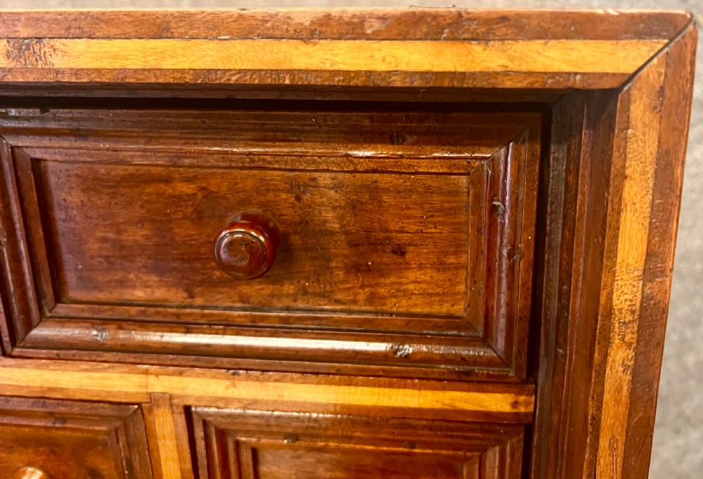 A 17th-century Spanish walnut Vargueno cabinet with an open drop-front writing flap revealing multiple fitted drawers, set on a trestle stand with iron stretchers. View VIII