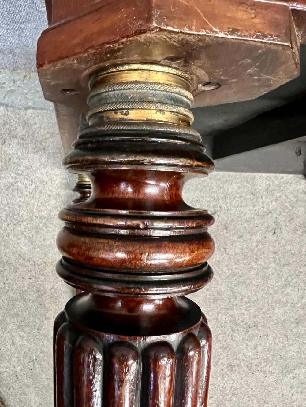 A 19th-century mahogany campaign table featuring turned fluted legs with brass castors and a rectangular polished top. View VII