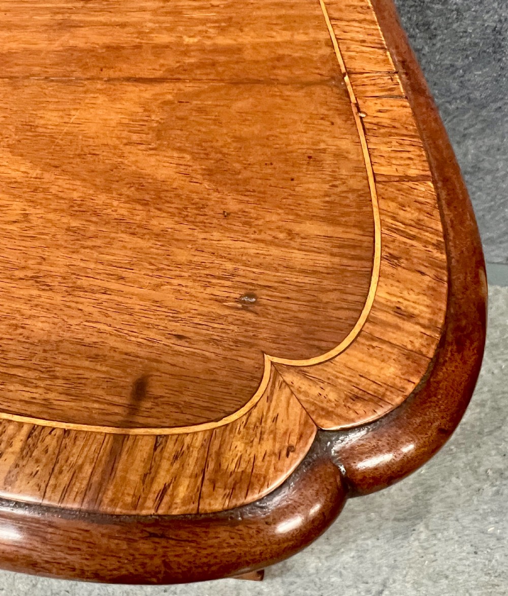 A George III mahogany kneehole desk featuring multiple drawers with brass swan-neck handles, a central recessed cupboard, and bracket feet. View IV