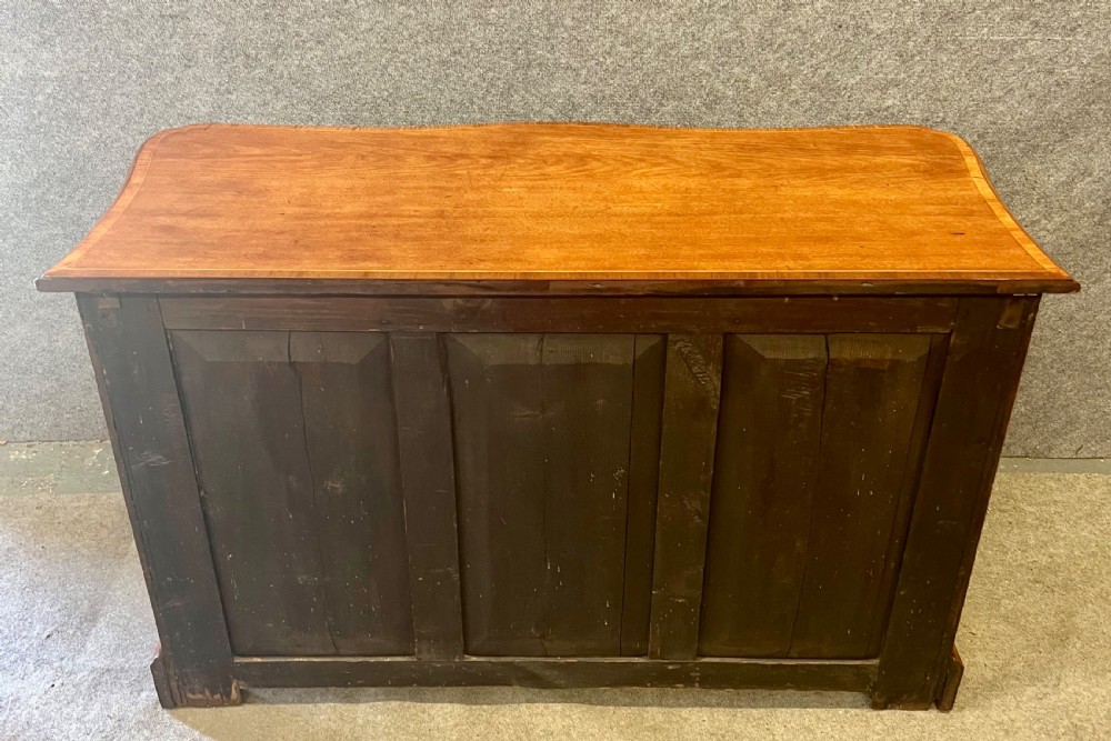 A George III mahogany kneehole desk featuring multiple drawers with brass swan-neck handles, a central recessed cupboard, and bracket feet. View VI