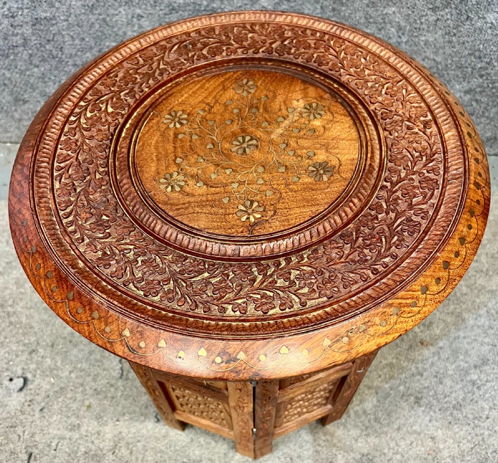 A small octagonal wooden side table featuring floral brass inlay on the top and pierced jali lattice panels on the base. View III