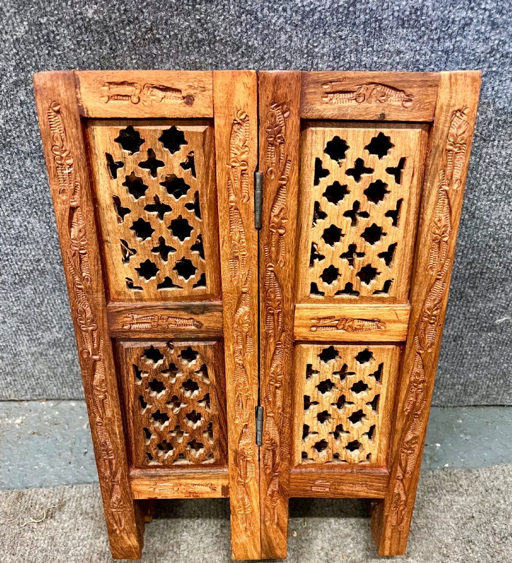 A small octagonal wooden side table featuring floral brass inlay on the top and pierced jali lattice panels on the base. View VIII