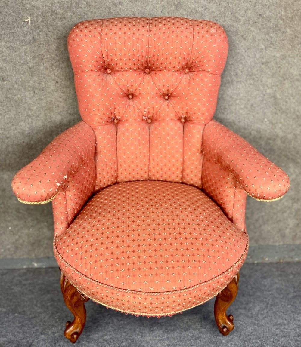 A pair of Victorian tub armchairs featuring patterned terracotta fabric, deep button tufting, and carved timber cabriole legs with brass castors. View III