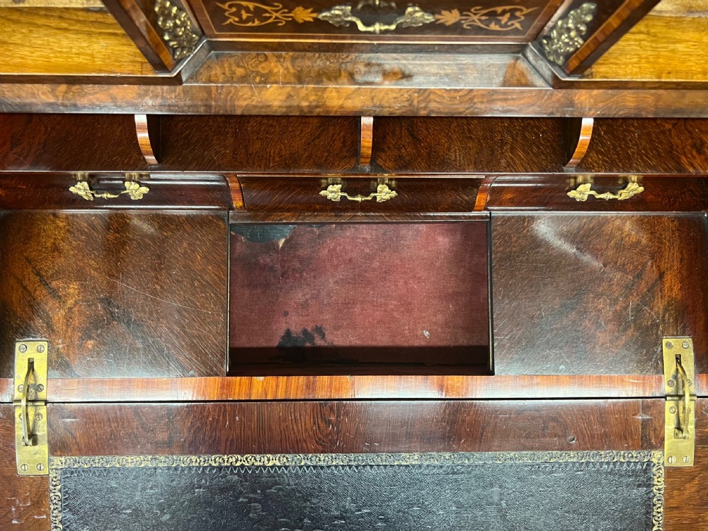 An antique Victorian inlaid walnut bureau de dame featuring a slant-front writing lid, floral marquetry, brass mounts, cabriole legs, and an upper cabinet with glazed doors. View V