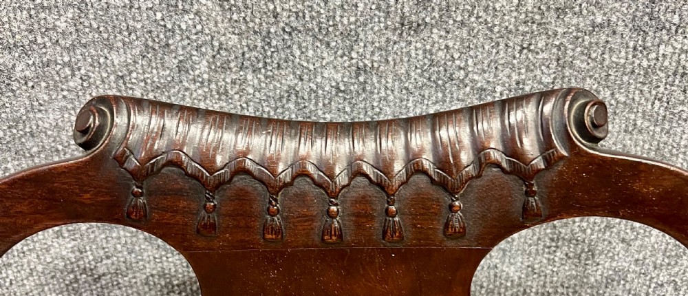 A dark mahogany George II style child armchair featuring a carved crest rail, vase-shaped back splat, shaped armrests, cabriole legs with pad feet, and a flame-stitch patterned seat. View IV