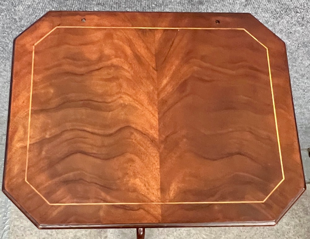An antique mahogany reading stand with an angled book rest featuring light wood string inlay, supported on a turned central column and a tripod base. View II