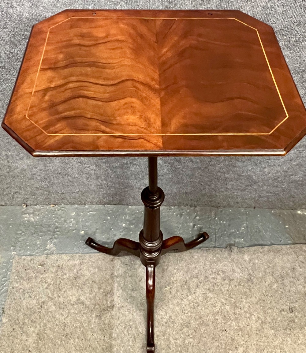 An antique mahogany reading stand with an angled book rest featuring light wood string inlay, supported on a turned central column and a tripod base. View III