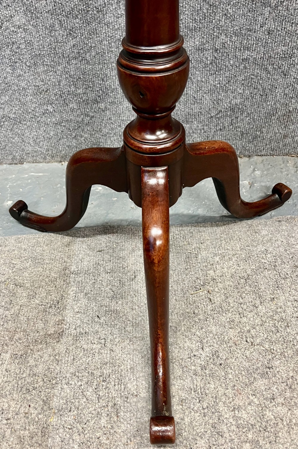 An antique mahogany reading stand with an angled book rest featuring light wood string inlay, supported on a turned central column and a tripod base. View VI