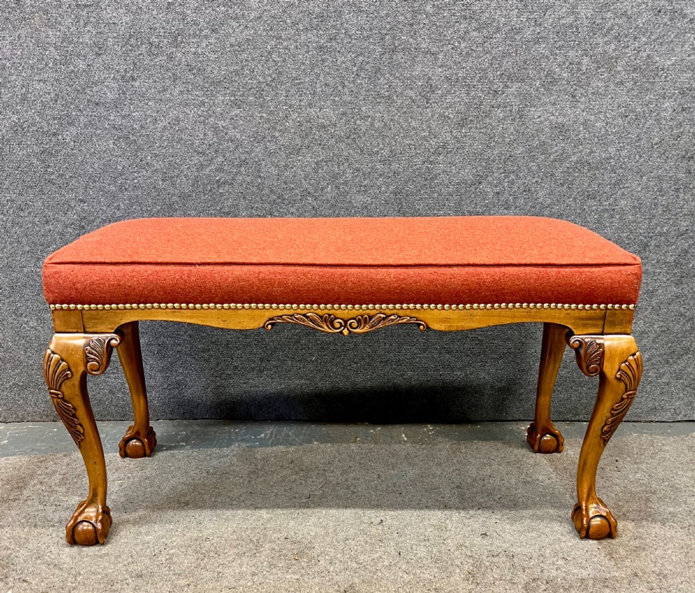An upholstered window seat featuring a terracotta red fabric cushion with brass stud detailing, supported by carved walnut cabriole legs ending in claw and ball feet. View II