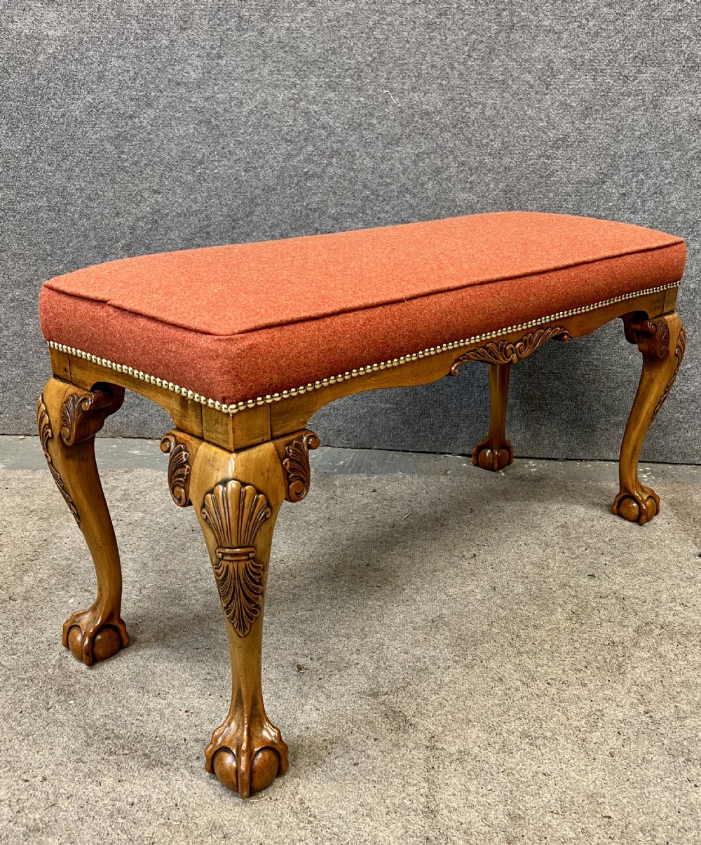 An upholstered window seat featuring a terracotta red fabric cushion with brass stud detailing, supported by carved walnut cabriole legs ending in claw and ball feet. View III