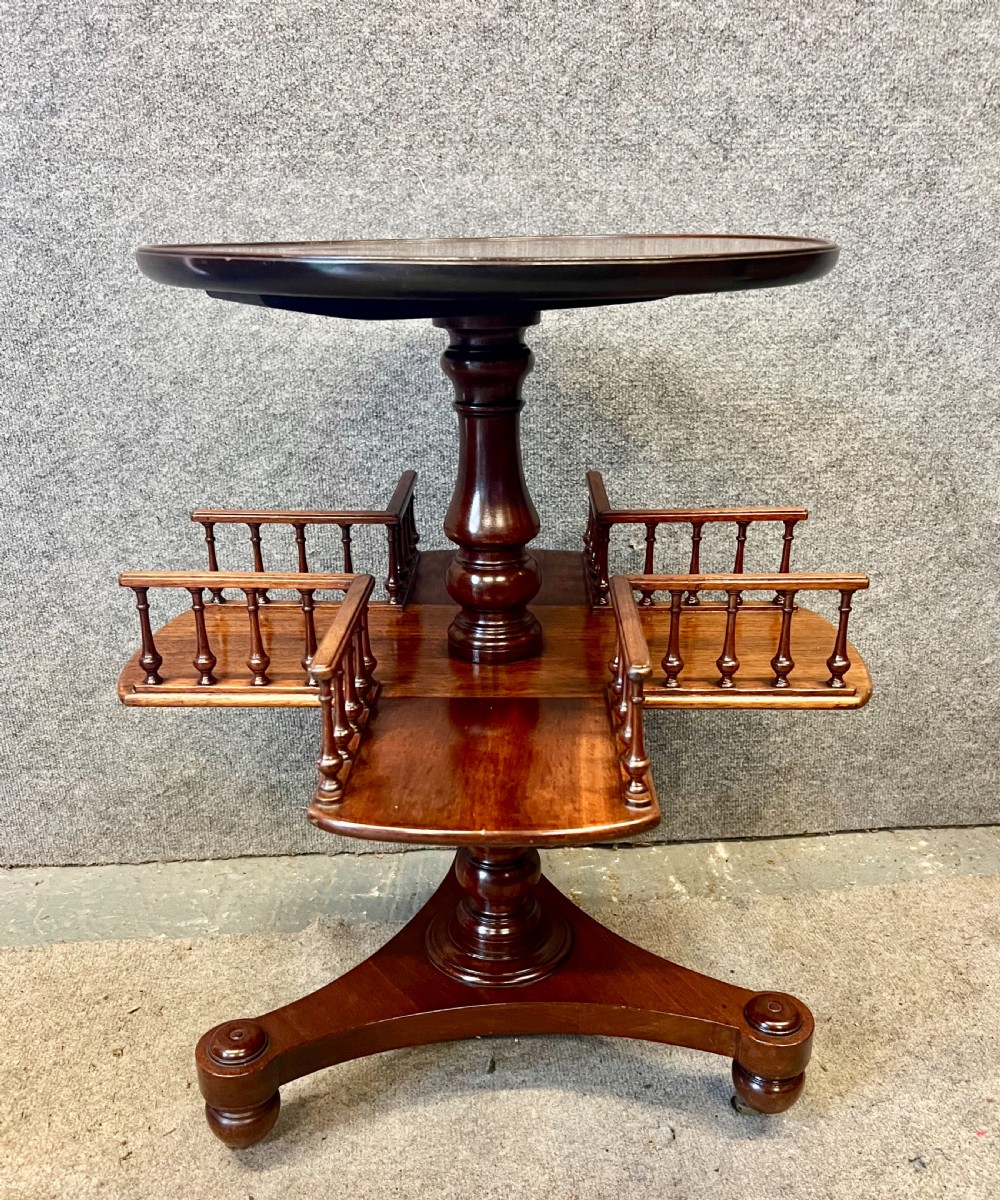 A circular mahogany revolving book mill table featuring a central turned column, four spindled book compartments, and a quadruped base. View III
