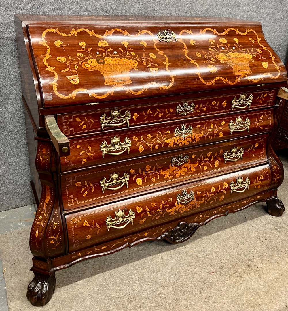 An antique Dutch marquetry writing bureau crafted from mahogany with detailed floral wood inlays, brass drop handles, and claw feet. View III