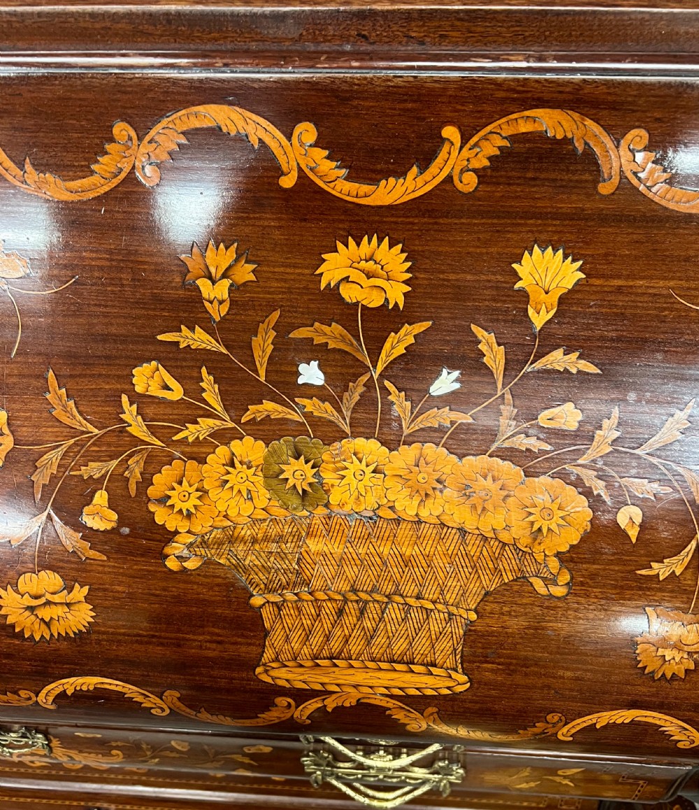 An antique Dutch marquetry writing bureau crafted from mahogany with detailed floral wood inlays, brass drop handles, and claw feet. View VI