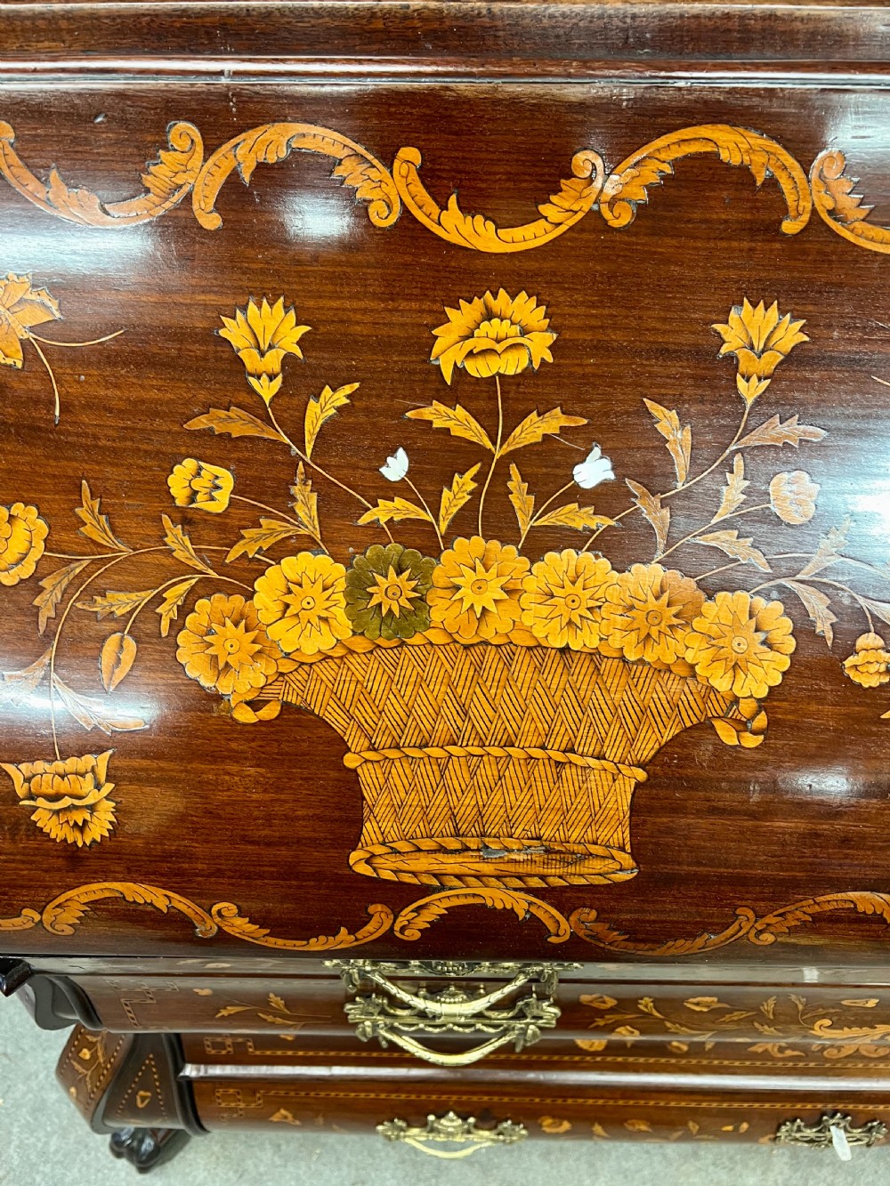 An antique Dutch marquetry writing bureau crafted from mahogany with detailed floral wood inlays, brass drop handles, and claw feet. View IX