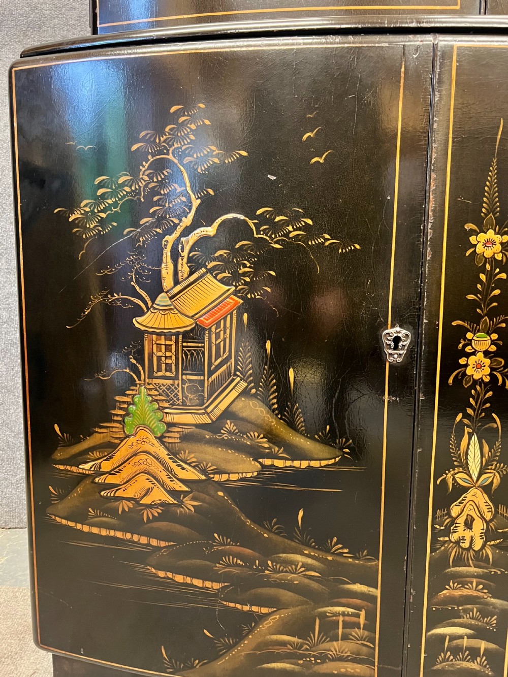 A two-tier black lacquered Art Deco cocktail cabinet featuring hand-painted gold and polychrome Chinoiserie figures and landscapes. View III