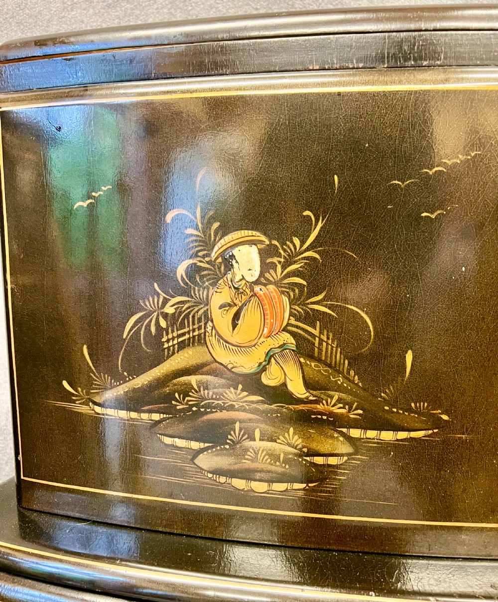 A two-tier black lacquered Art Deco cocktail cabinet featuring hand-painted gold and polychrome Chinoiserie figures and landscapes. View VI