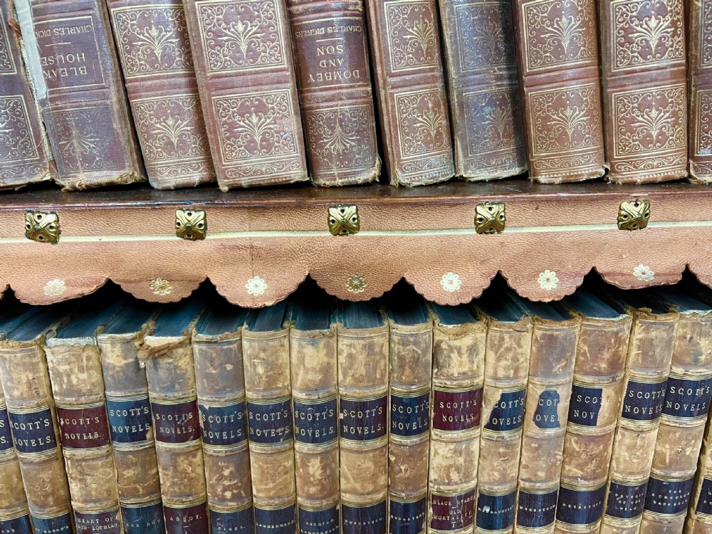 A two-tier Victorian pollard oak secretaire bookcase featuring upper glazed doors with books above a lower cabinet with carved relief panels. View XIII