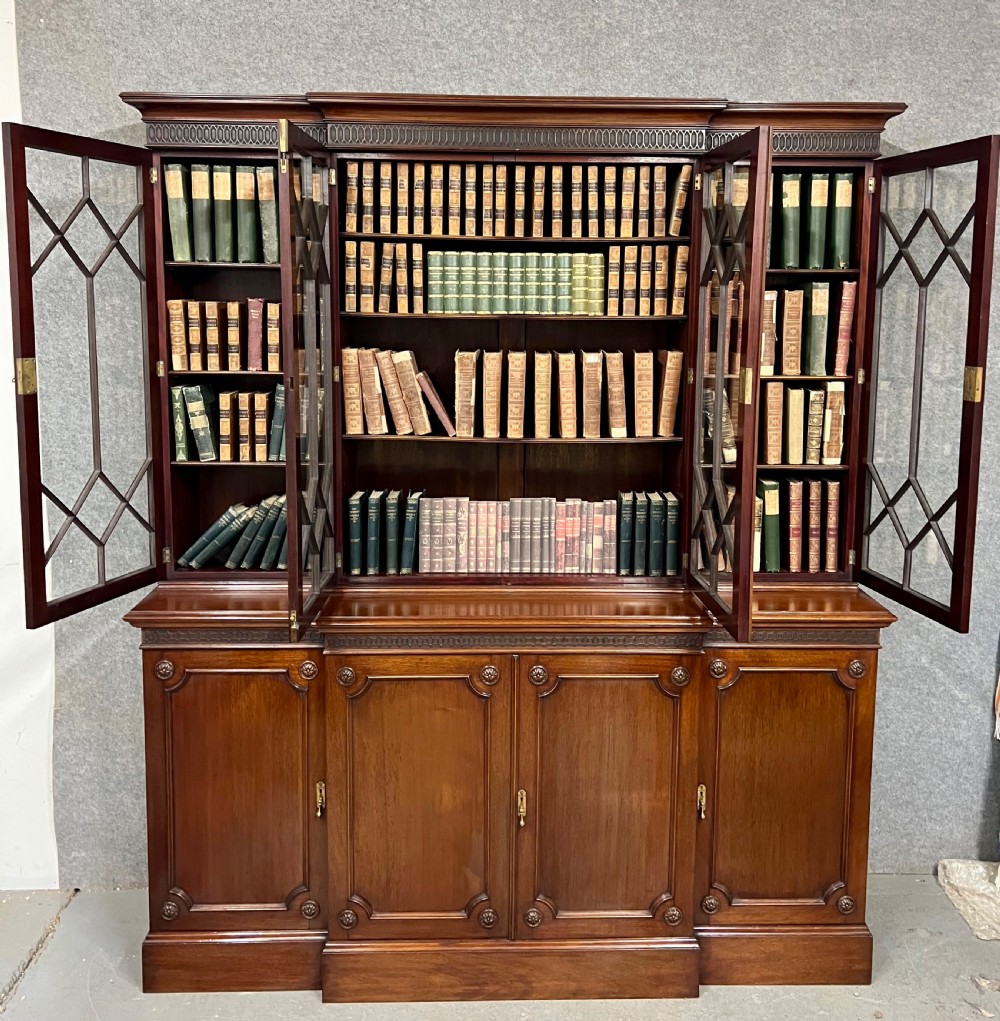 A large mahogany breakfront bookcase featuring four lattice-glazed upper doors above four panelled lower cupboard doors. View II