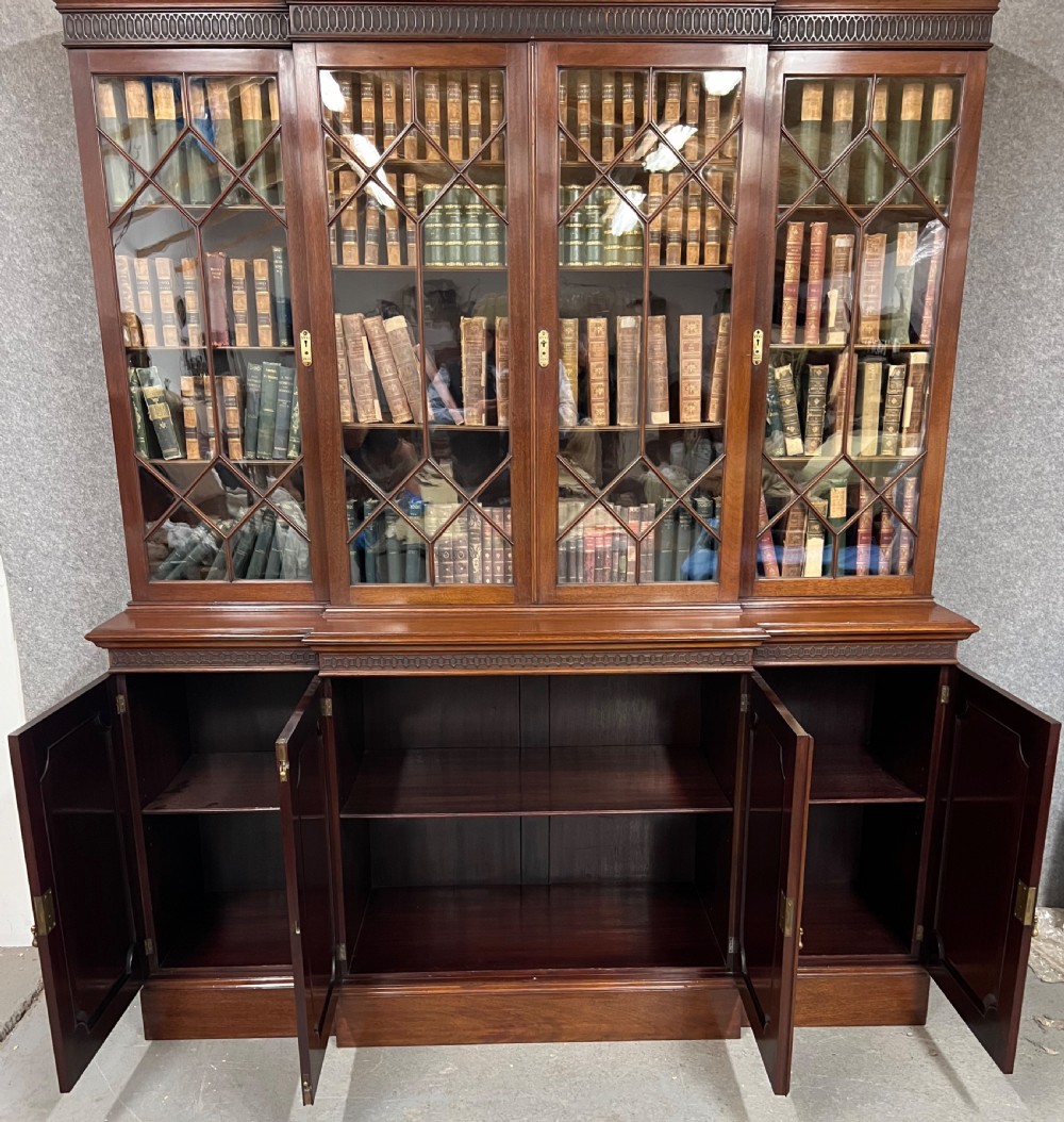 A large mahogany breakfront bookcase featuring four lattice-glazed upper doors above four panelled lower cupboard doors. View III