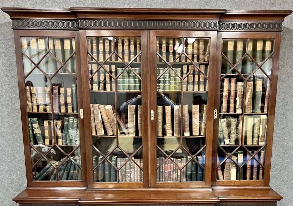 A large mahogany breakfront bookcase featuring four lattice-glazed upper doors above four panelled lower cupboard doors. View XIV