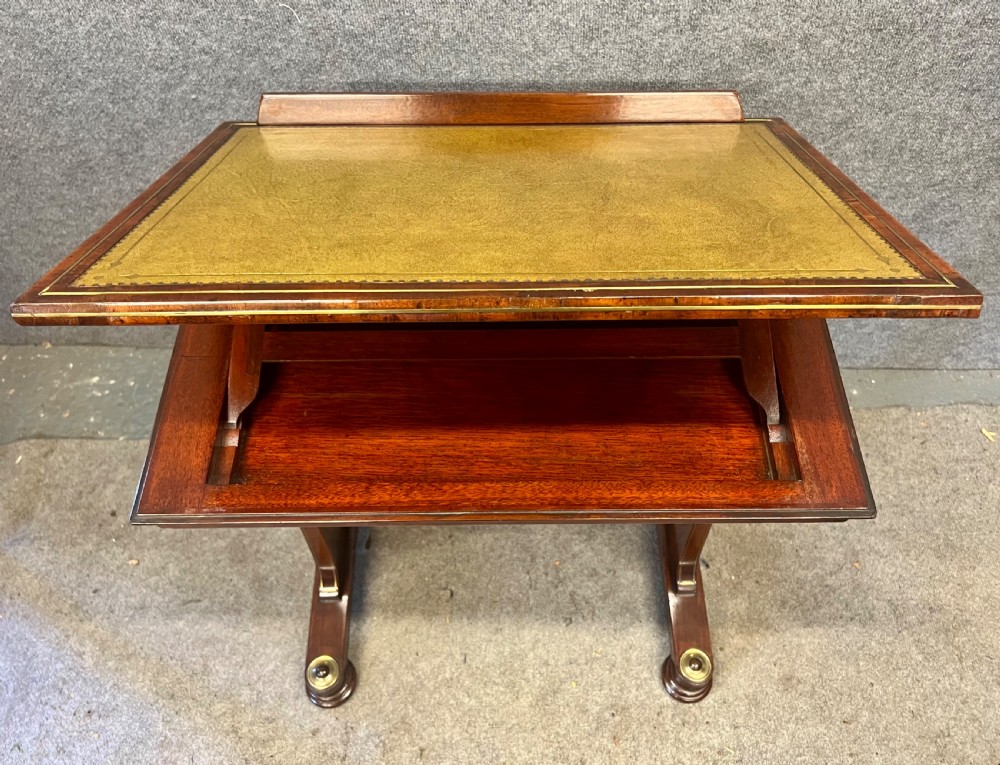 A Regency mahogany adjustable reading table with brass inlay and a gold tooled leather tilting top. View X
