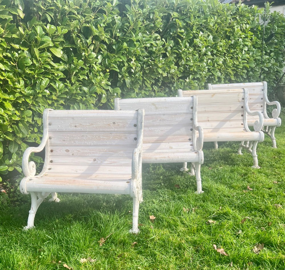 Set of four Victorian garden armchairs featuring white painted cast iron scrollwork frames and slatted timber seats. View II