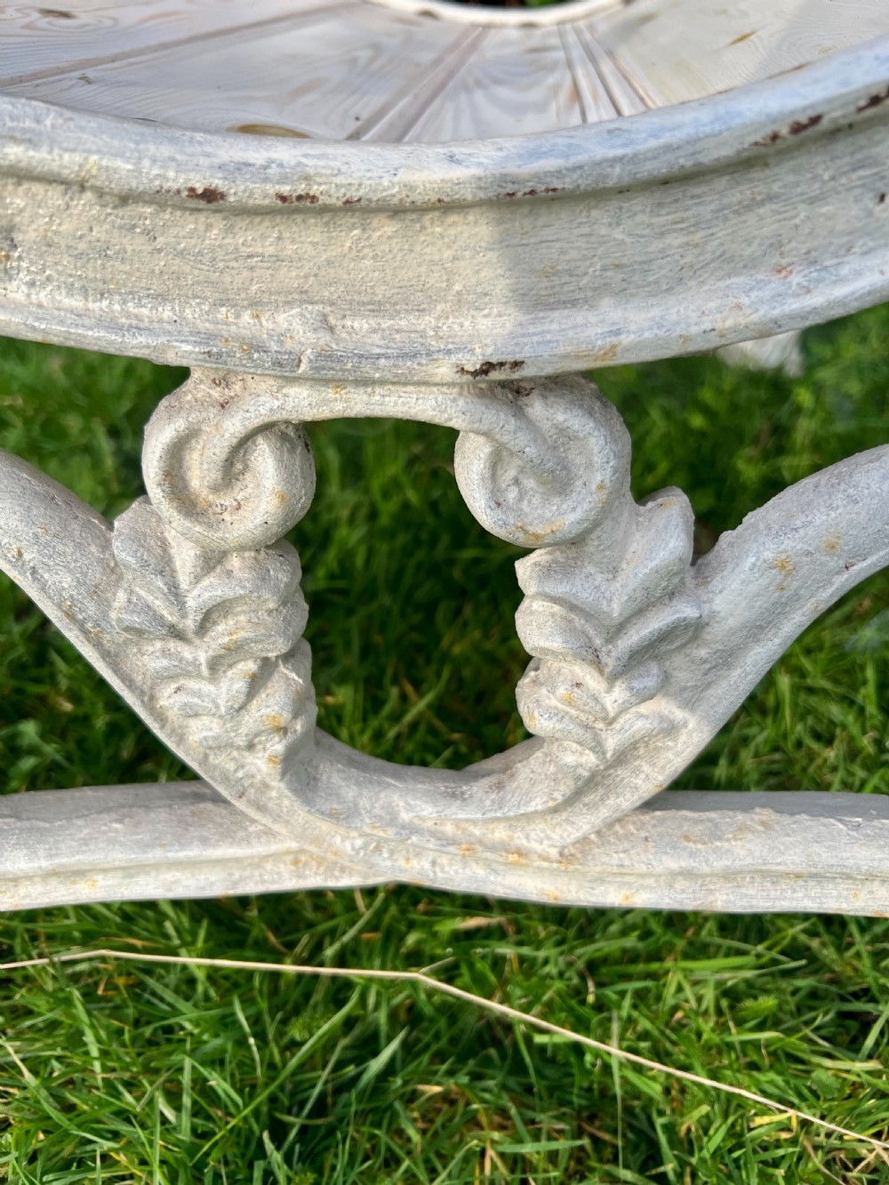 Set of four Victorian garden armchairs featuring white painted cast iron scrollwork frames and slatted timber seats. View IV