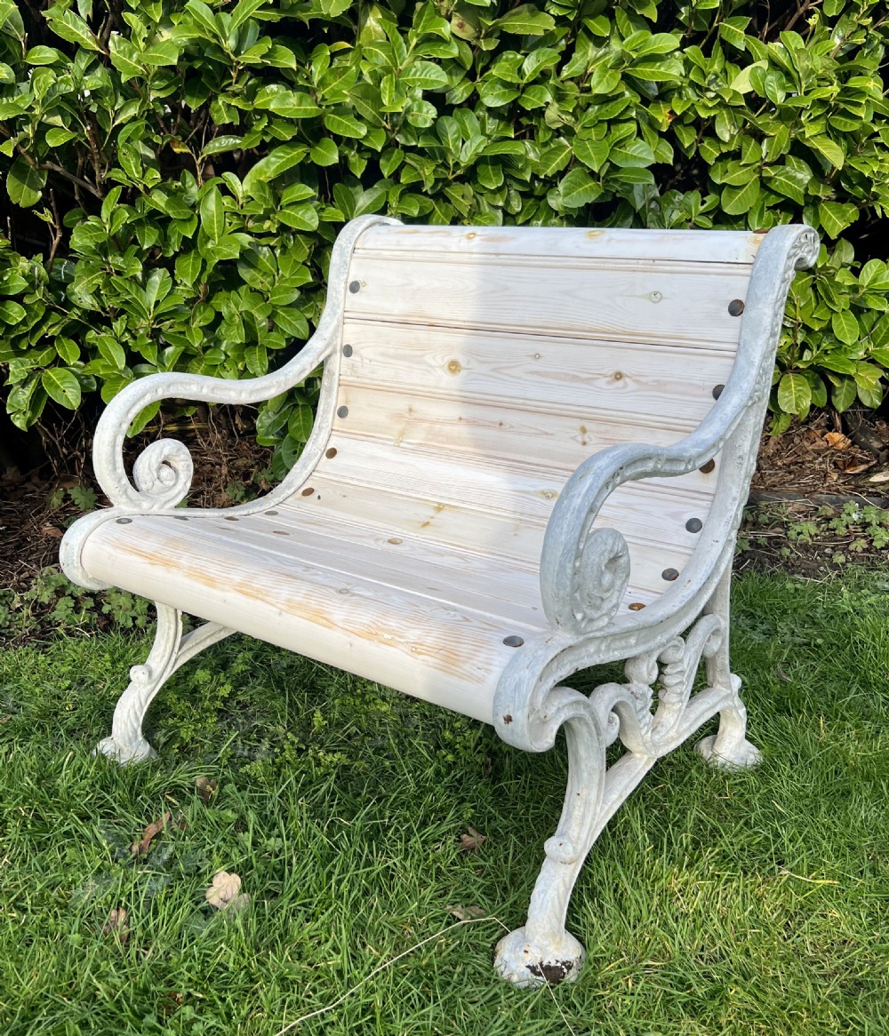 Set of four Victorian garden armchairs featuring white painted cast iron scrollwork frames and slatted timber seats. View IX