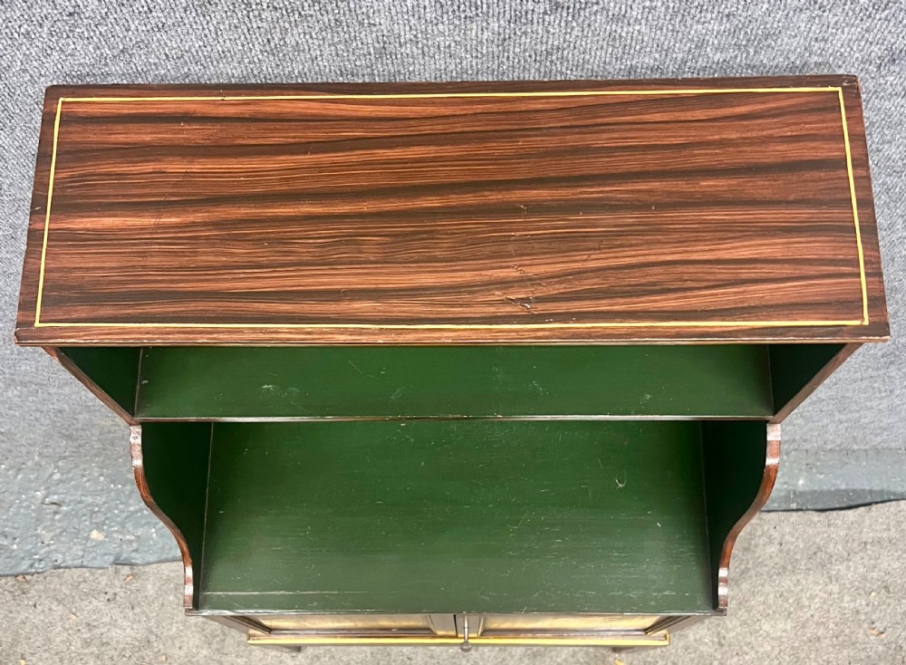 A Regency style dark wood waterfall bookcase featuring two open green-painted shelves over a double-door lower cabinet on tapered legs. View XI