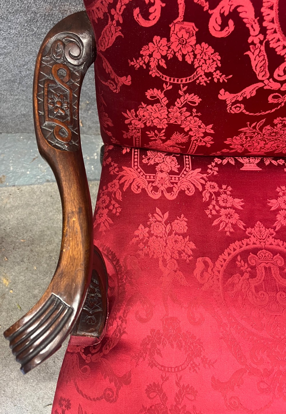 A 19th-century mahogany Gainsborough library chair upholstered in patterned crimson red damask, featuring carved cabriole legs and claw and ball feet. View III