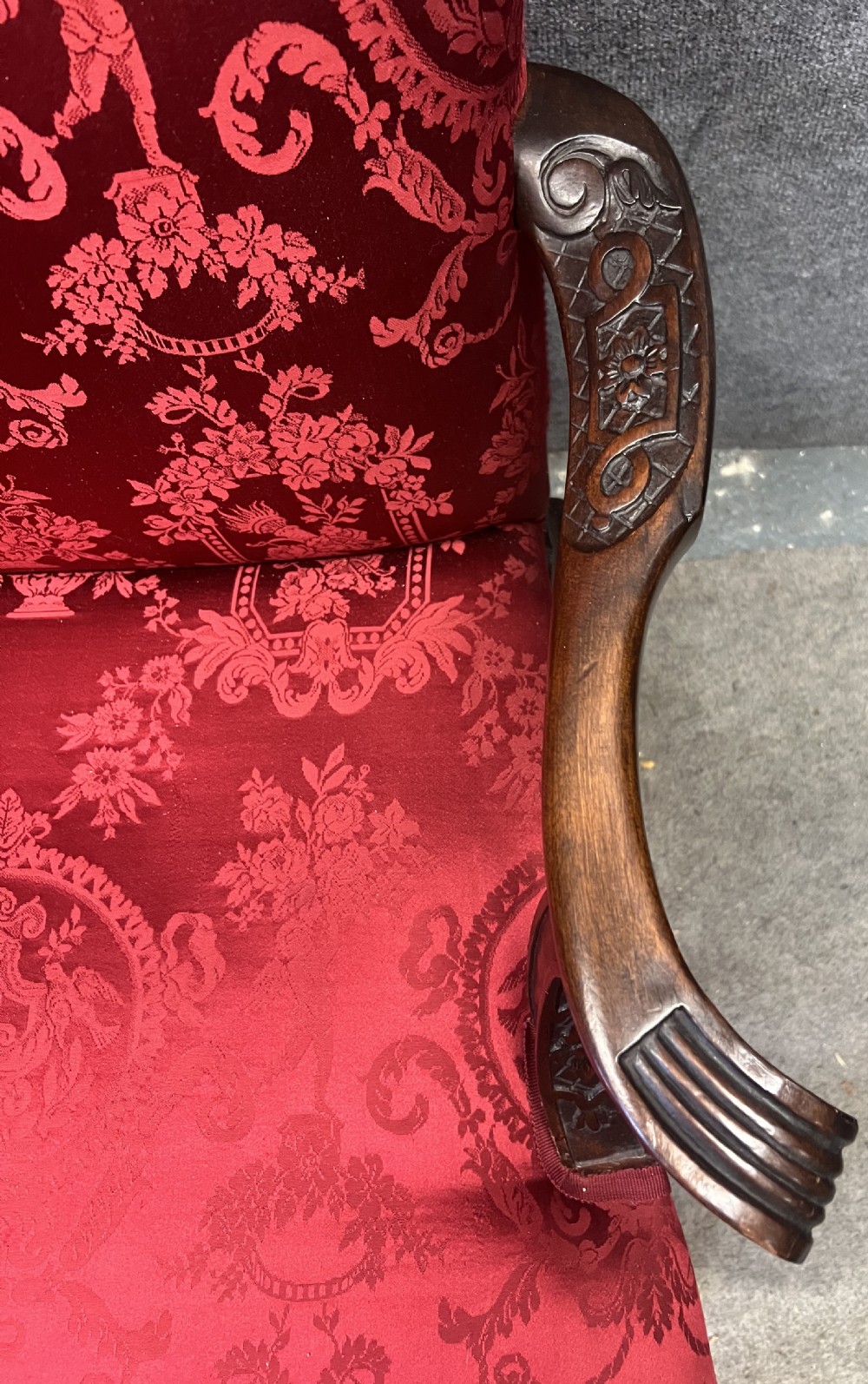 A 19th-century mahogany Gainsborough library chair upholstered in patterned crimson red damask, featuring carved cabriole legs and claw and ball feet. View IV