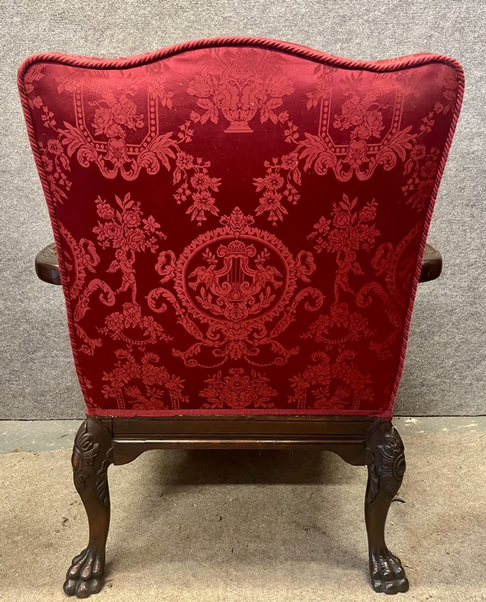 A 19th-century mahogany Gainsborough library chair upholstered in patterned crimson red damask, featuring carved cabriole legs and claw and ball feet. View XI