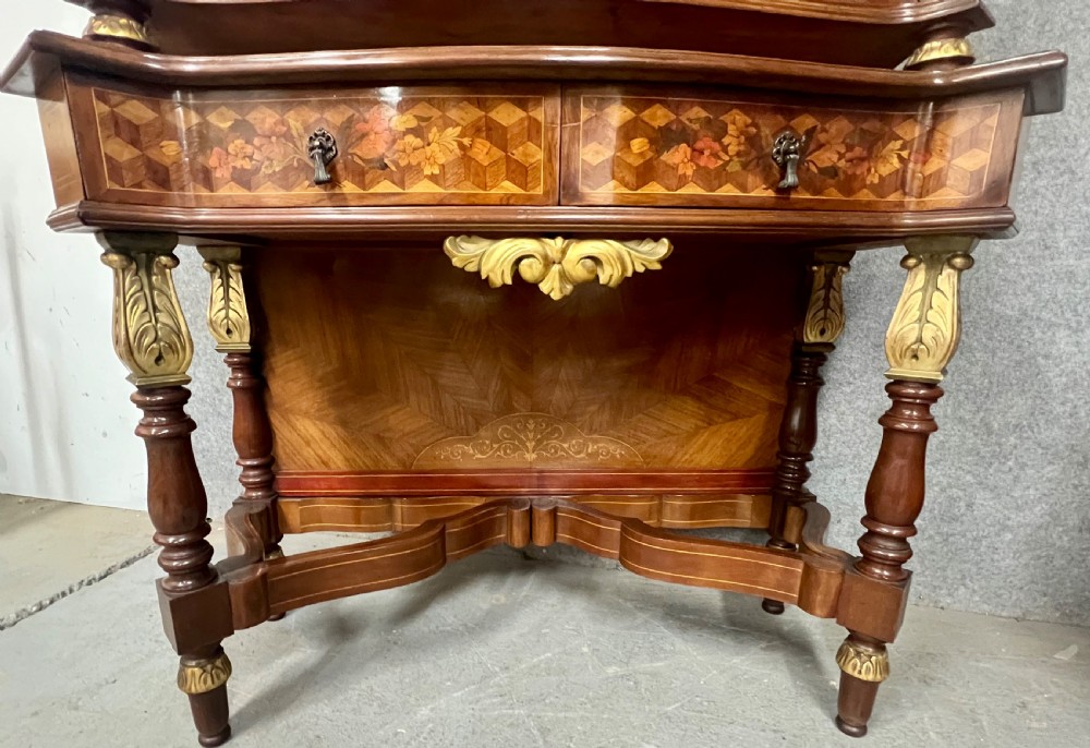 A two-tier dark walnut cocktail cabinet featuring intricate floral marquetry, a serpentine front, gilded carved accents, and turned legs with a contoured stretcher. View IX