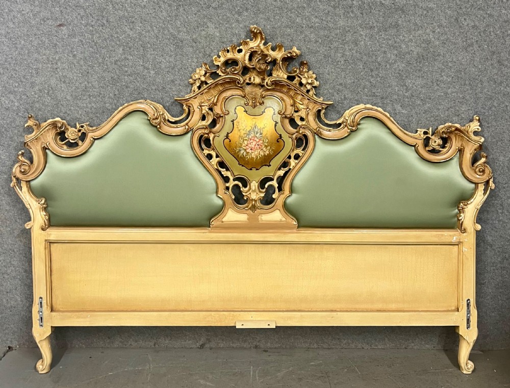 An ornate French Rococo style king size bed frame featuring cream painted and carved wood with gilded accents, sage green upholstered headboard panels, and hand-painted floral cartouches. View II