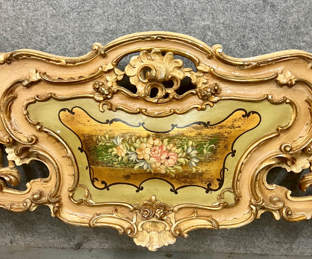 An ornate French Rococo style king size bed frame featuring cream painted and carved wood with gilded accents, sage green upholstered headboard panels, and hand-painted floral cartouches. View VII