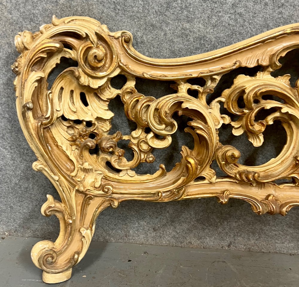 An ornate French Rococo style king size bed frame featuring cream painted and carved wood with gilded accents, sage green upholstered headboard panels, and hand-painted floral cartouches. View VIII