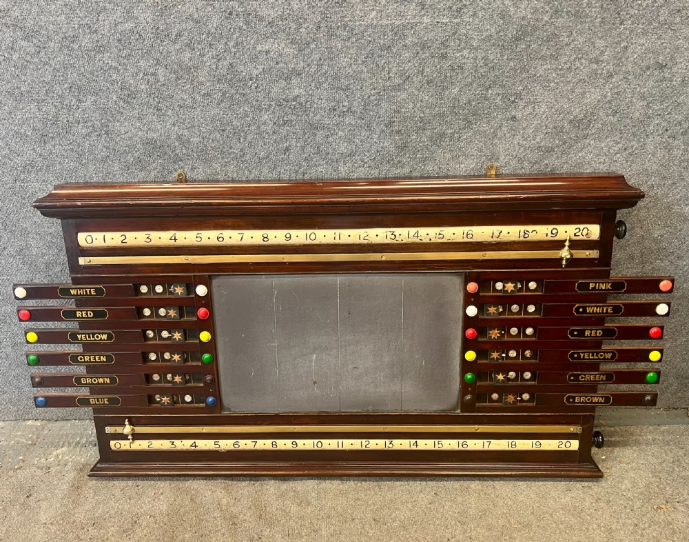 An antique dark mahogany snooker scoreboard featuring sliding pointer bars with coloured markers, brass fittings, and a central slate panel.